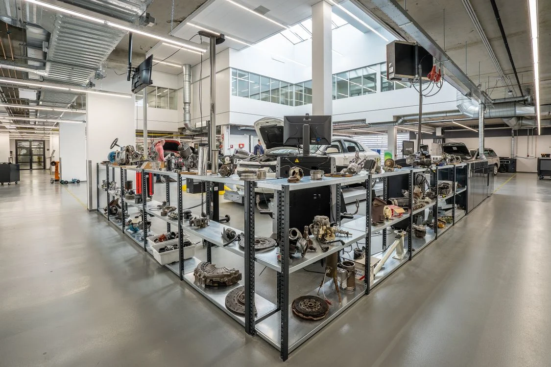 Automotive workshop with shelves of engine components, photographed by Mike van Schoonderwalt; stock photo, not the YIM premises